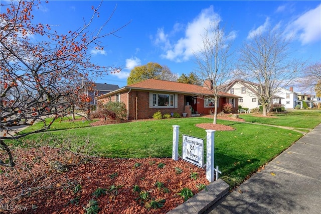 ranch-style home with a front lawn