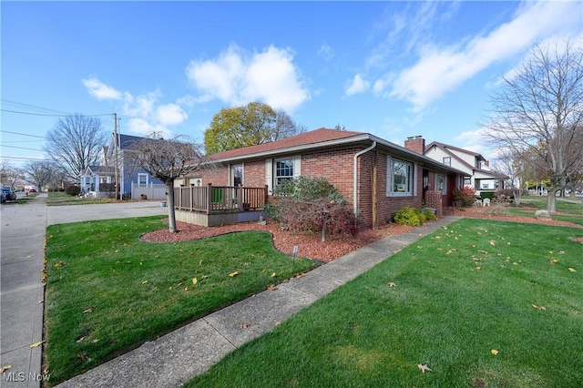 view of property exterior with a deck and a lawn