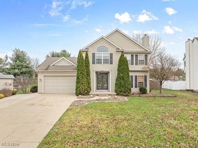 front facade featuring french doors, a garage, and a front lawn