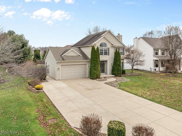 view of front of property with a front yard and a garage