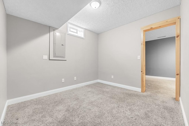 basement with carpet floors, a textured ceiling, and electric panel