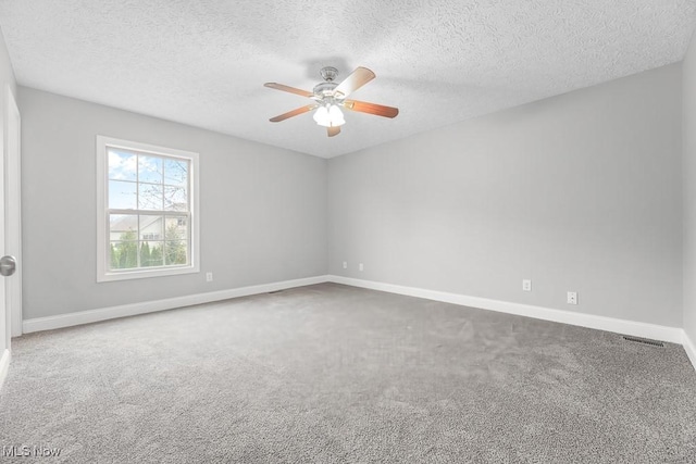 unfurnished room featuring a textured ceiling, carpet floors, and ceiling fan