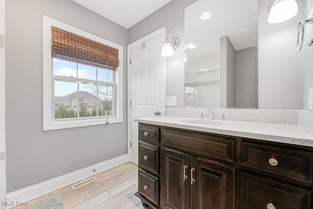 bathroom featuring vanity and an enclosed shower