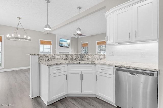 kitchen featuring pendant lighting, white cabinets, stainless steel dishwasher, ceiling fan, and tasteful backsplash