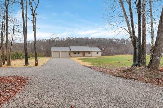 view of front of home featuring a front yard and a garage