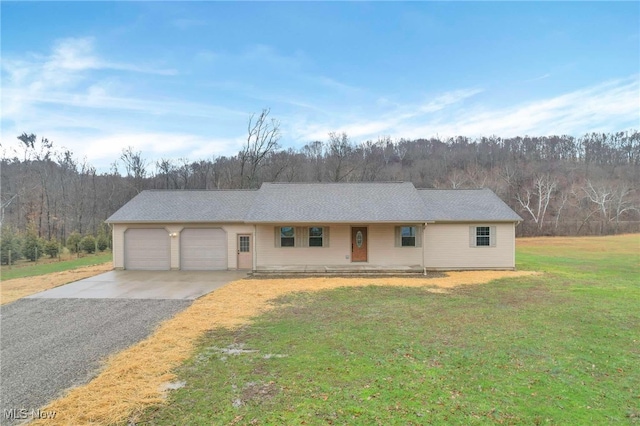 single story home with a garage and a front lawn