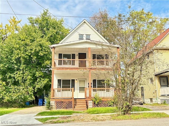 view of front of property with a porch and a balcony