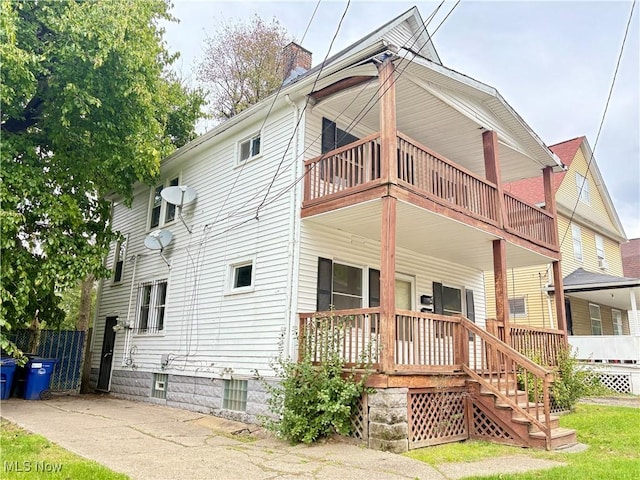 rear view of property with covered porch