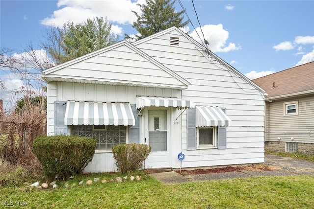 back of property featuring a lawn