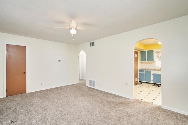 carpeted spare room with ceiling fan