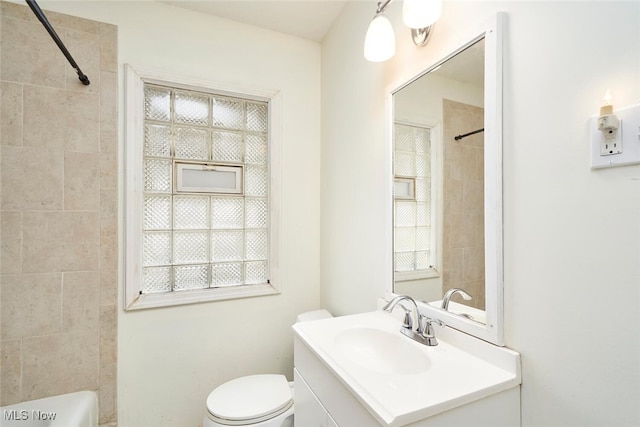 full bathroom featuring vanity, toilet, and tiled shower / bath