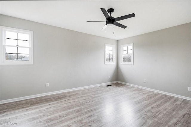 empty room featuring ceiling fan and light hardwood / wood-style floors