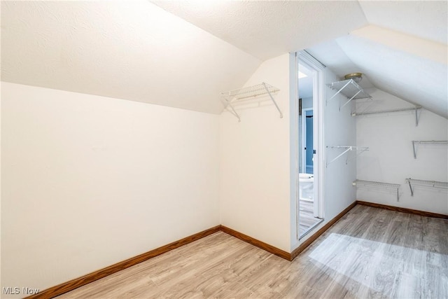 spacious closet with lofted ceiling and wood-type flooring