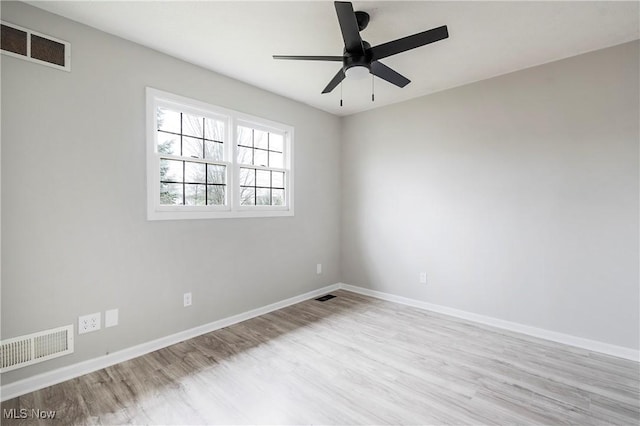 empty room with ceiling fan and light hardwood / wood-style flooring