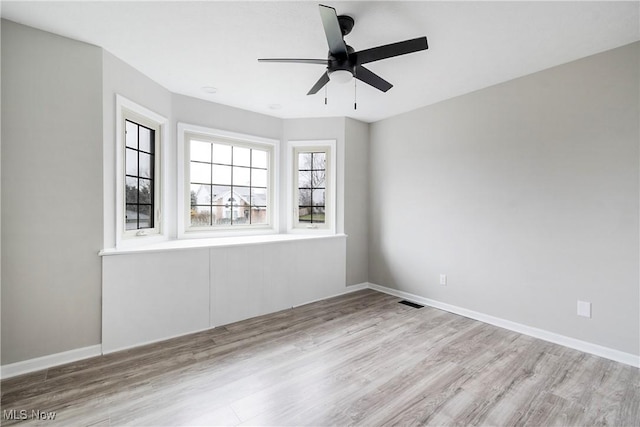 empty room featuring light hardwood / wood-style flooring and ceiling fan