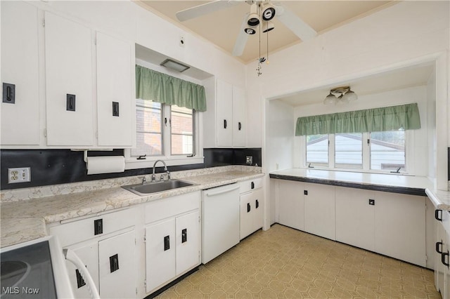 kitchen featuring white cabinets, dishwasher, a healthy amount of sunlight, and sink