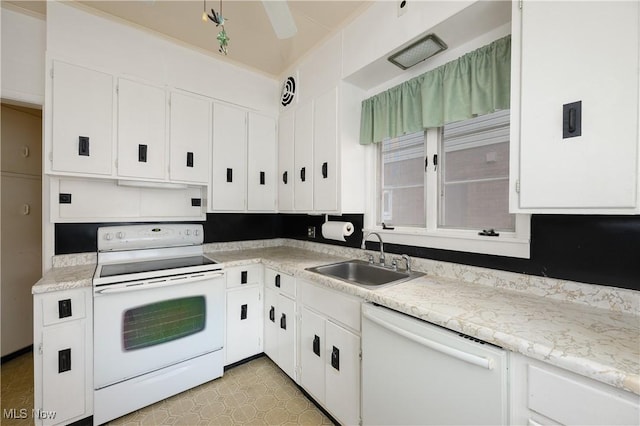 kitchen featuring sink, white cabinets, light tile patterned flooring, and white appliances