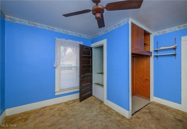 interior space with carpet floors and ceiling fan