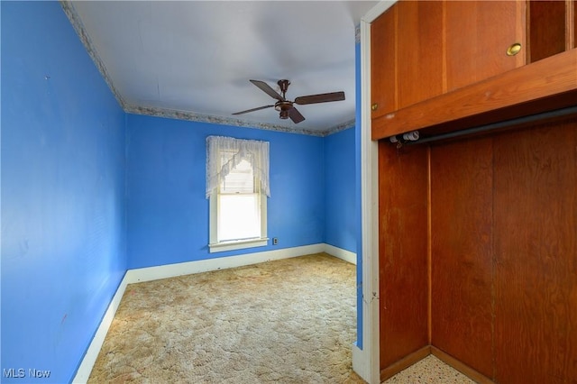 carpeted empty room with ceiling fan