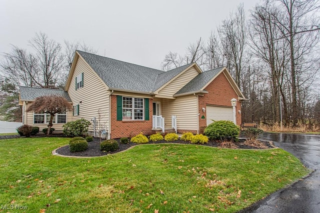 view of front of house with a garage and a front lawn