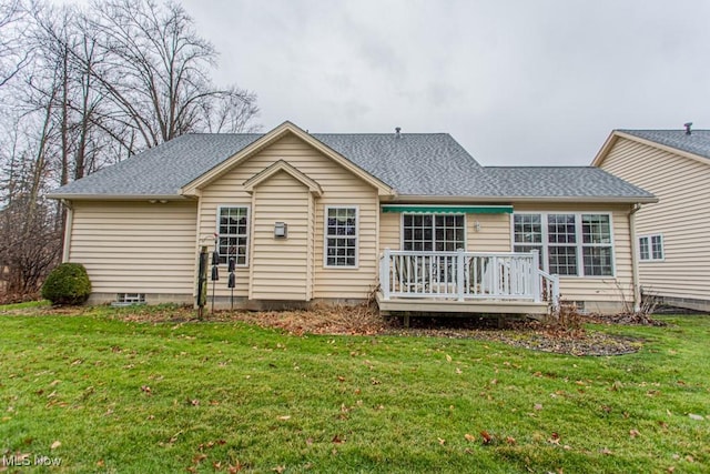 rear view of property featuring a yard and a wooden deck