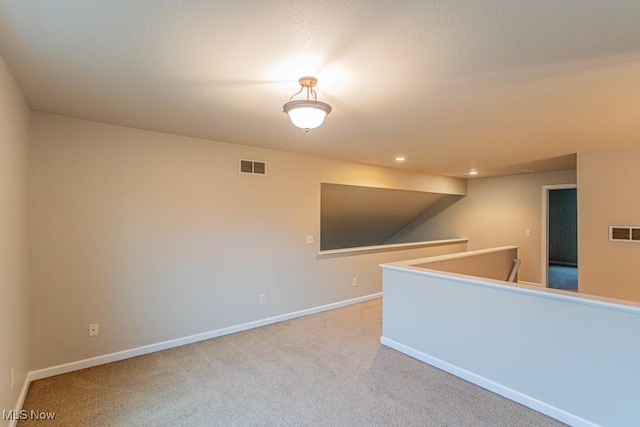 unfurnished room with light colored carpet