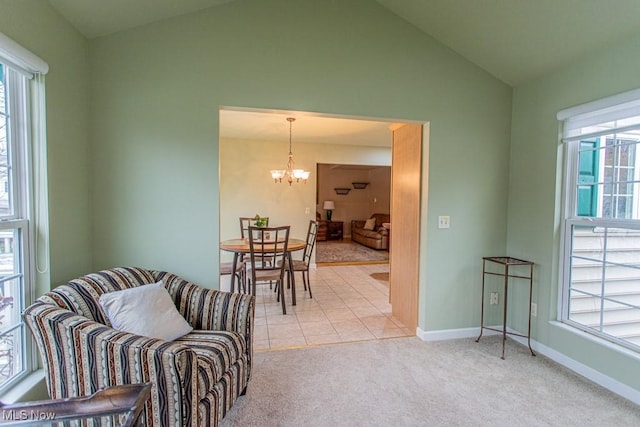 interior space featuring light colored carpet, an inviting chandelier, and lofted ceiling