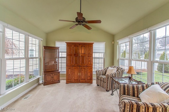 sitting room featuring ceiling fan, lofted ceiling, light carpet, and a wealth of natural light