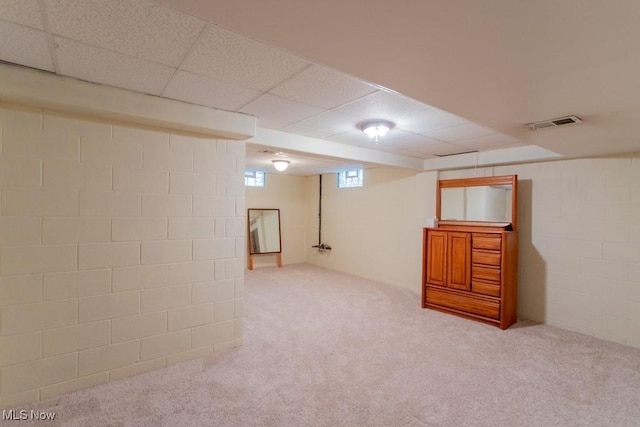 basement featuring carpet flooring and a drop ceiling