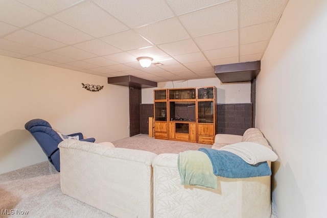 living room with a drop ceiling