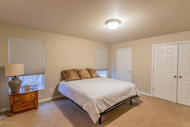 carpeted bedroom featuring a textured ceiling