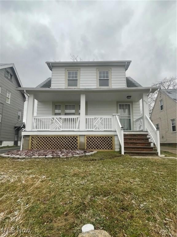 view of front of house with covered porch and a front yard