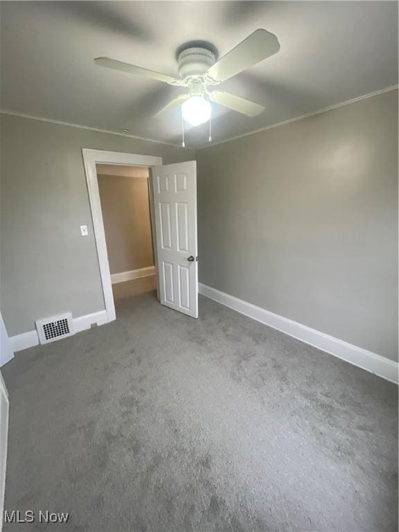 empty room with carpet, ceiling fan, and crown molding