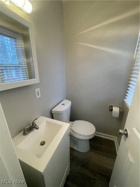 bathroom featuring hardwood / wood-style flooring, vanity, toilet, and plenty of natural light