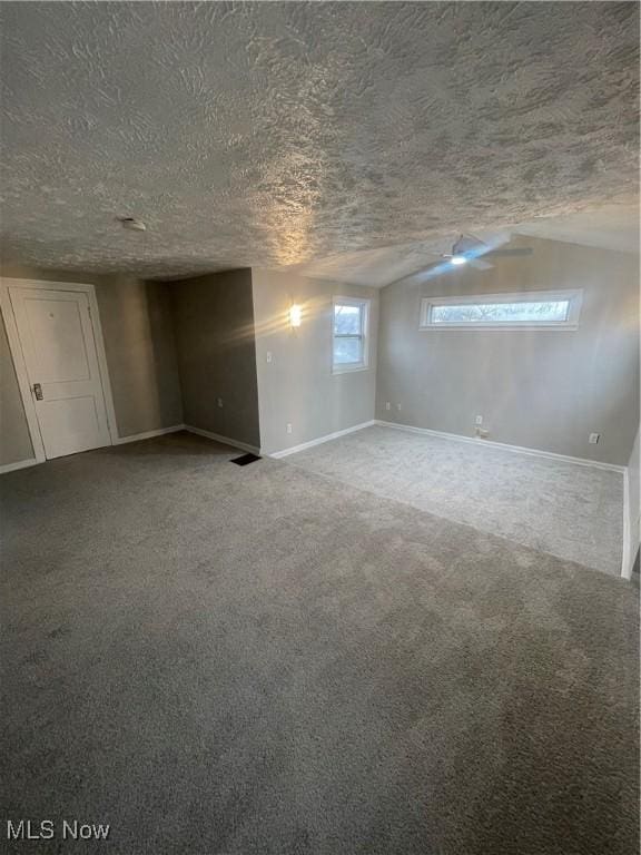 basement with carpet flooring and a textured ceiling