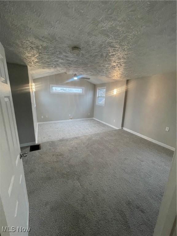 unfurnished room featuring carpet and a textured ceiling