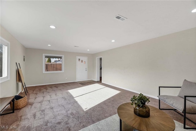 living area with light carpet