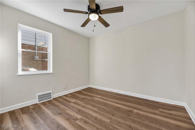 unfurnished room featuring dark hardwood / wood-style floors and ceiling fan