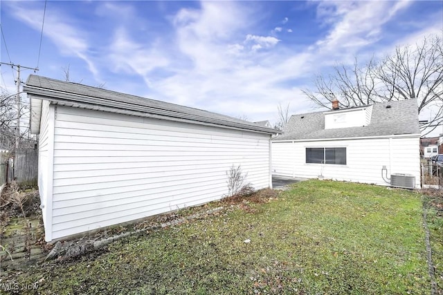 view of property exterior featuring a yard and central AC