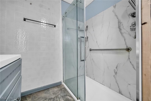 bathroom with a tile shower and tile walls