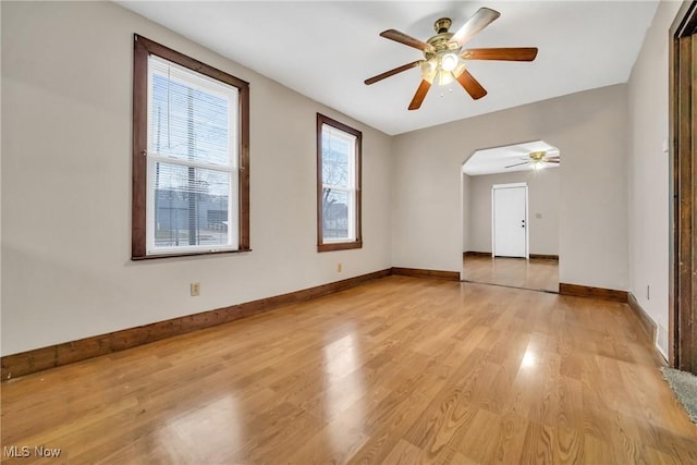 spare room featuring ceiling fan and light hardwood / wood-style floors