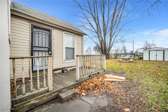 wooden deck featuring a storage unit