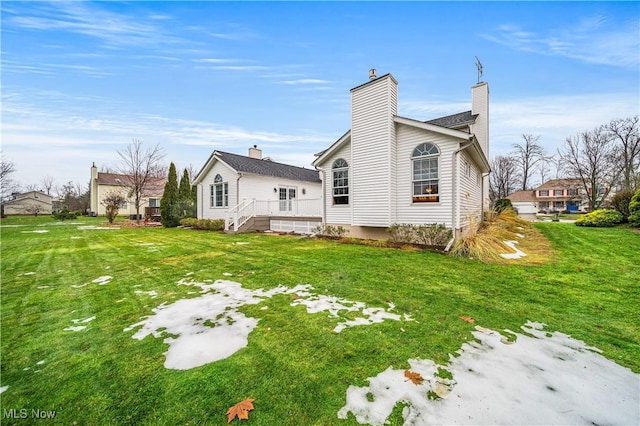 rear view of property with a yard