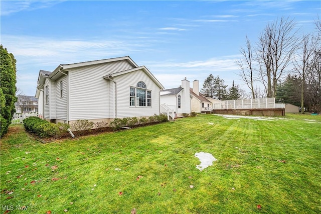 view of side of home featuring a yard