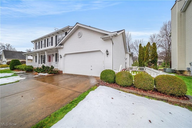 view of front of home with covered porch and a garage