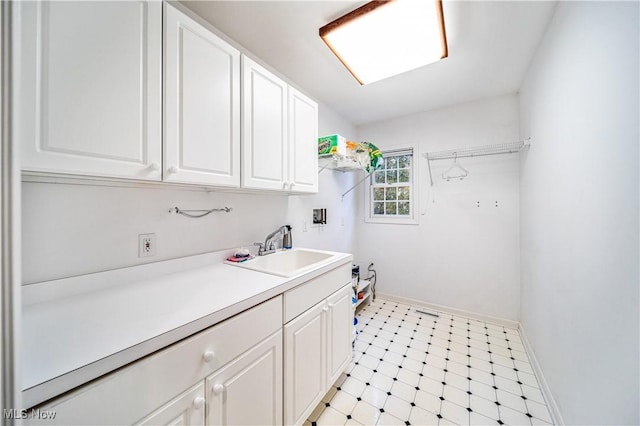 laundry area with cabinets, washer hookup, and sink