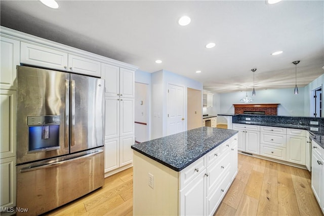 kitchen featuring a center island, hanging light fixtures, light hardwood / wood-style flooring, stainless steel refrigerator with ice dispenser, and white cabinets