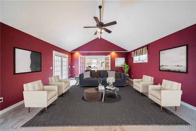 carpeted living room with ceiling fan, vaulted ceiling, and french doors