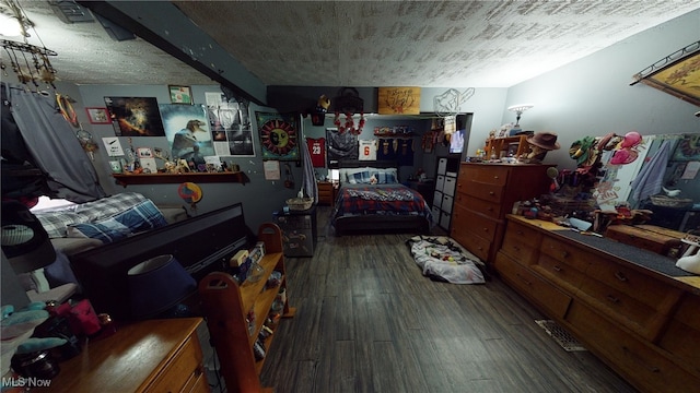 bedroom featuring dark hardwood / wood-style flooring and a textured ceiling