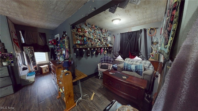 interior space with dark wood-type flooring and a textured ceiling